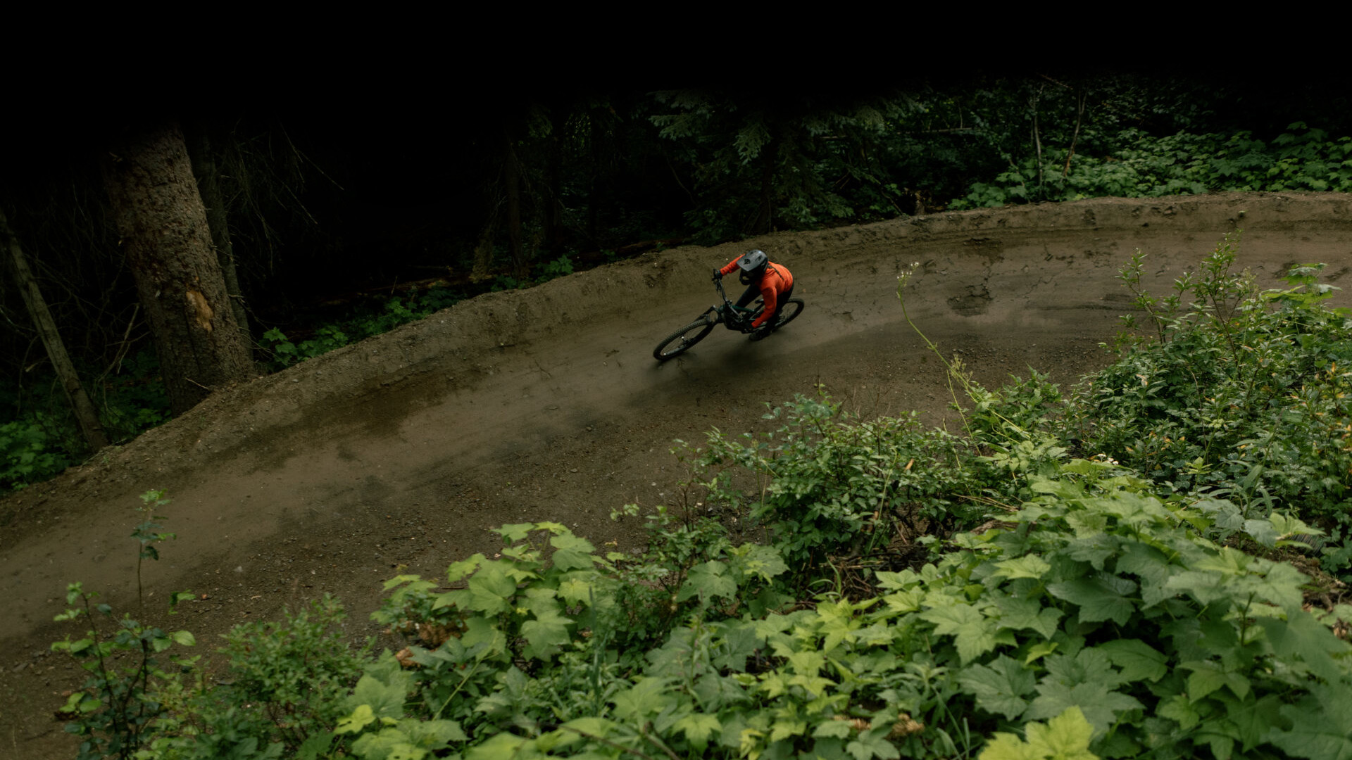 Mountain biker riding a berm through the forest at Silver Star Bike Park